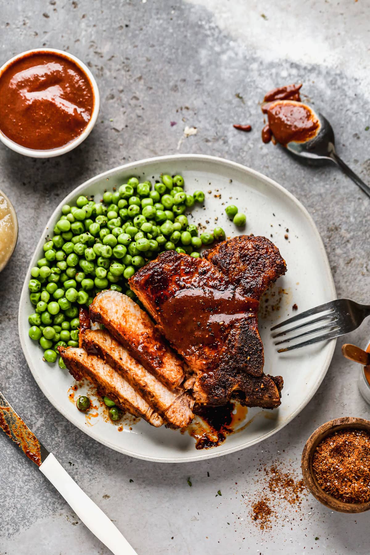 A plate with air fryer pork chops and peas