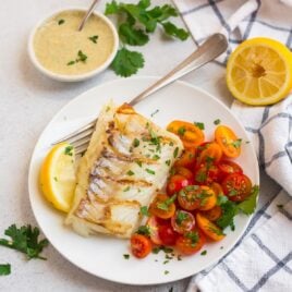 Grilled cod with cilantro yogurt sauce and tomatoes