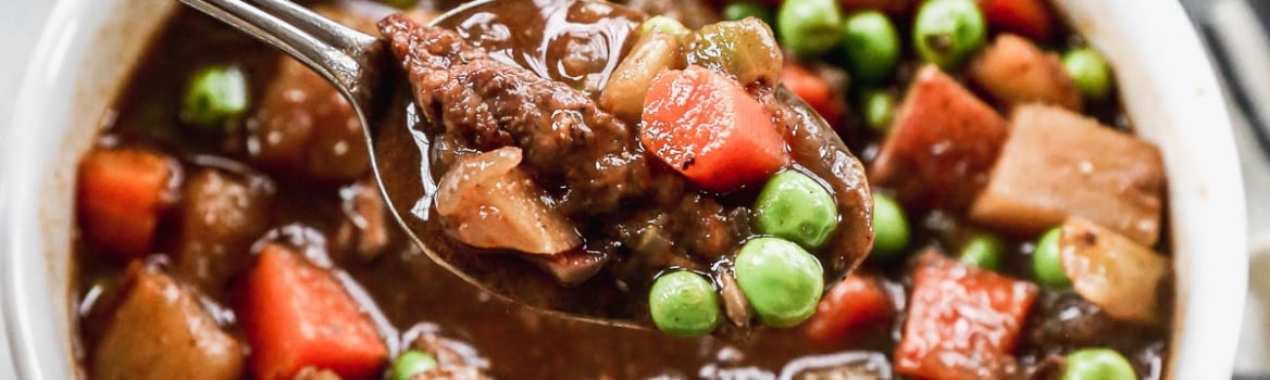 The BEST Crock Pot Beef Stew ever in a bowl with a spoon