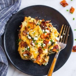 Wake up to this Healthy Breakfast Crockpot Egg Casserole. It cooks overnight in the slow cooker while you sleep! Made with bread, bacon, spinach, artichokes, and cheese, it’s a savory twist on French toast that is perfect for holidays and weekend guests. Simple, delicious, and easy to make vegetarian or gluten free.