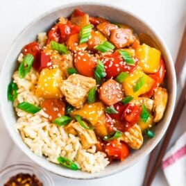Easy healthy crockpot sweet and sour chicken with peppers, chicken breasts, and sesame seeds
