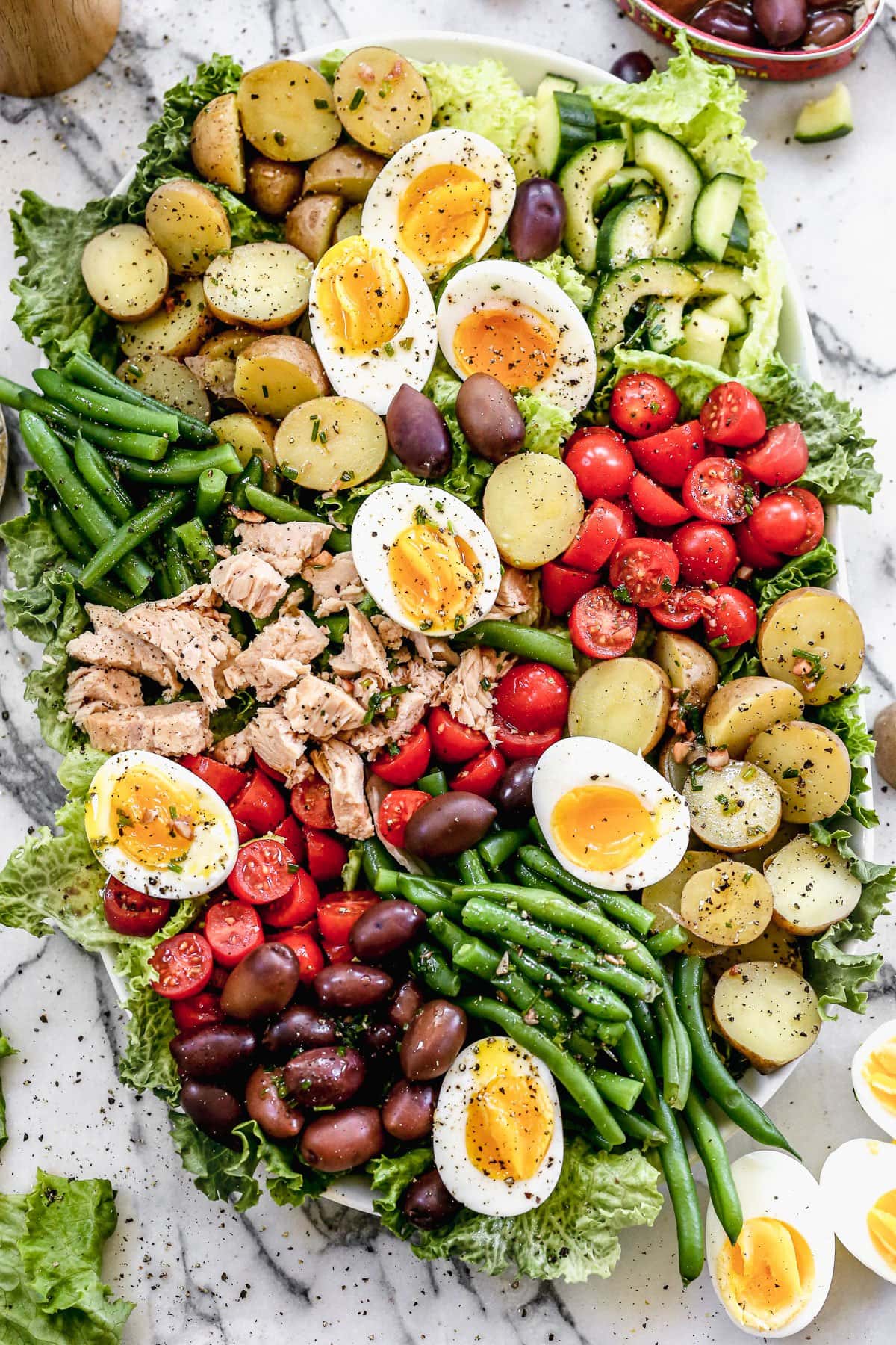 Nicoise salad served on a platter with eggs