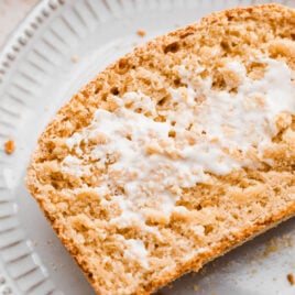 a slice of a Whole Wheat English Muffin Bread recipe with butter