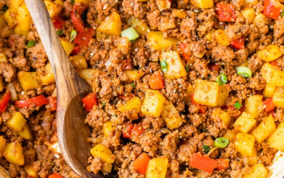 Ground beef and potatoes with red peppers in a pot