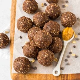 Healthy chocolate peanut butter energy balls on a wooden board