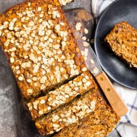 A loaf of oatmeal banana bread with oats on top