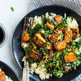 Easy Sesame Tofu Stir Fry. Crispy tofu with spinach, broccoli, or any fresh vegetables you love. This vegan recipe is packed with flavor in a simple, delicious Asian garlic ginger sauce. Serve with rice or noodles.