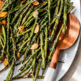 A plate of roasted green beans with almonds