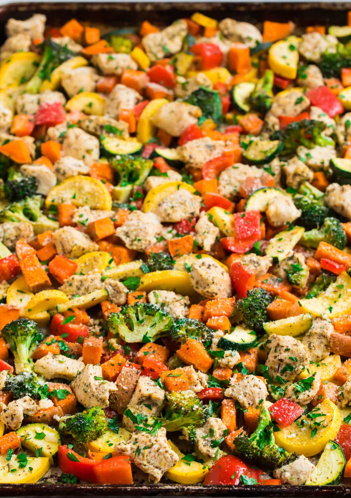 A sheet pan full of vegetables and chicken